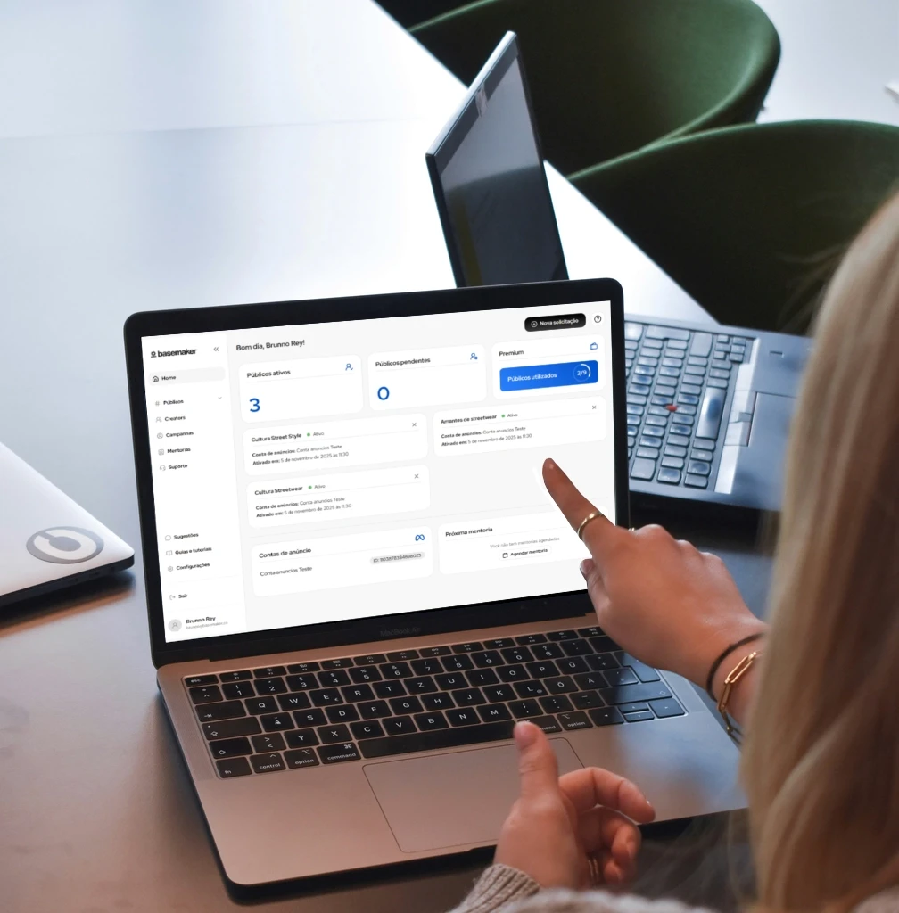 woman in brown sweater using macbook pro